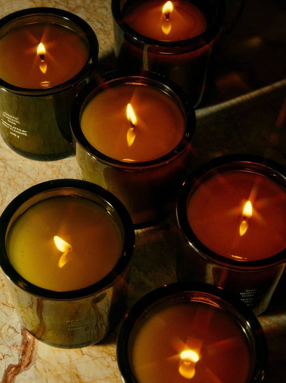 Lit Candles On A Marble Surface