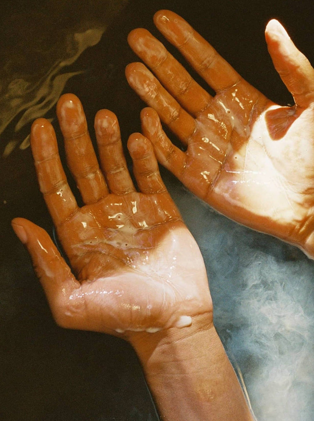 Two Wet Foamy Hands With Palms Facing Up