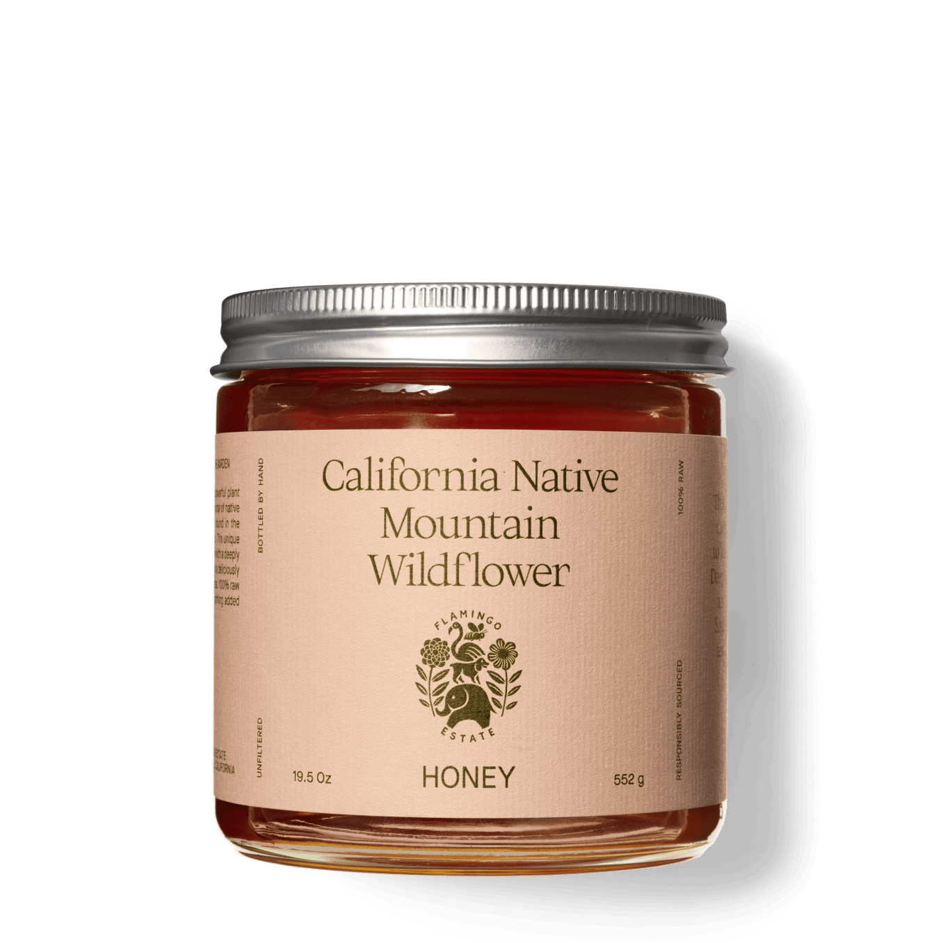 A glass jar filled with honey labeled "California Native Mountain Wildflower Honey, Flamingo Estate."