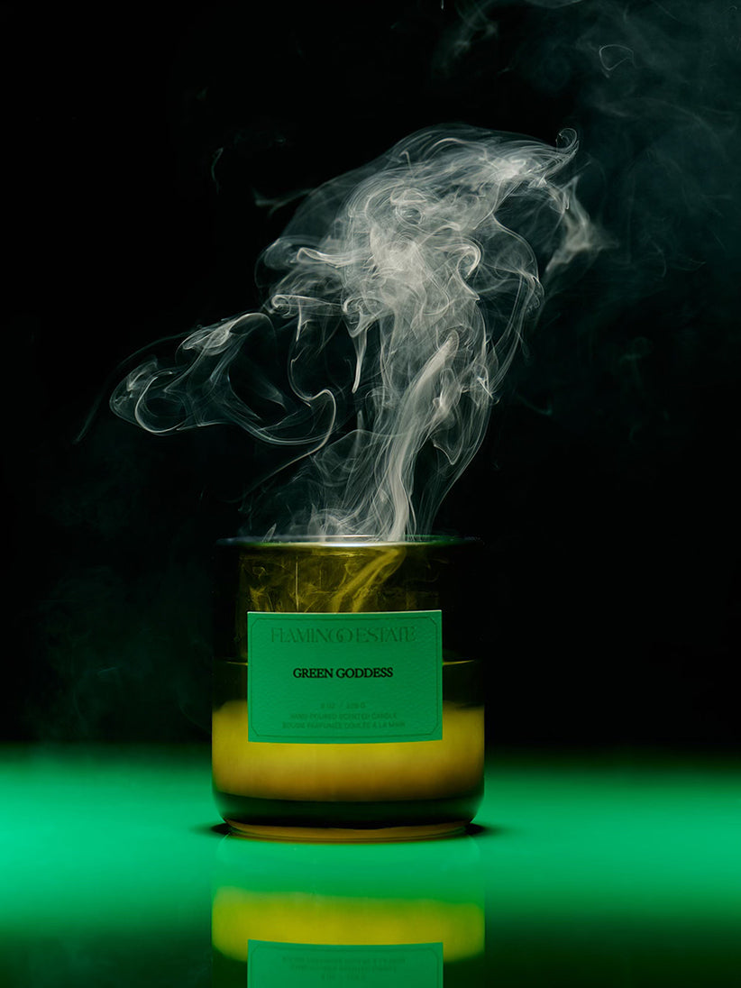 Green Goddess Candle with smoke and a green label on a dark background