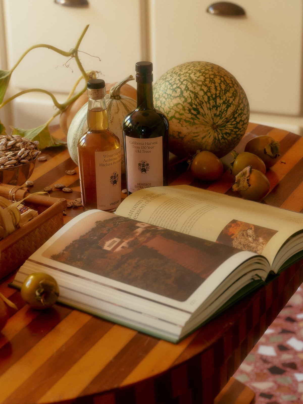 Open cookbook displaying images and text on a wooden table.