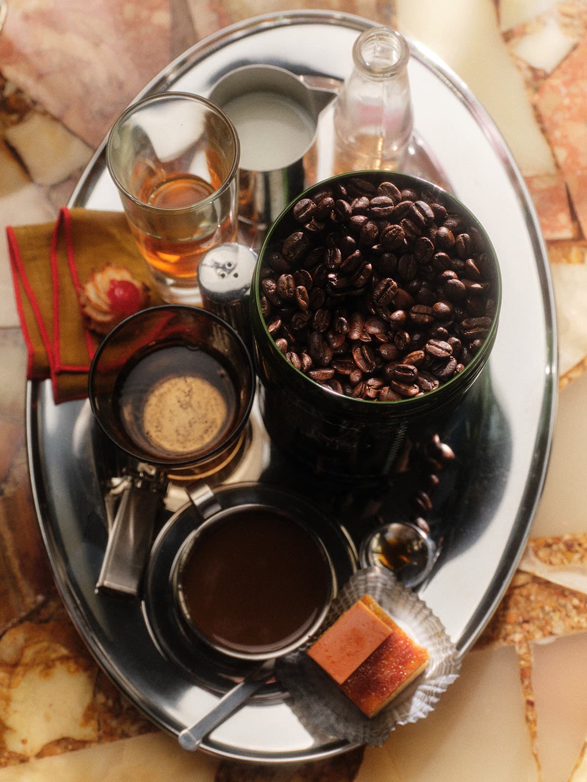 A silver tray holds a variety of coffee brewing items.