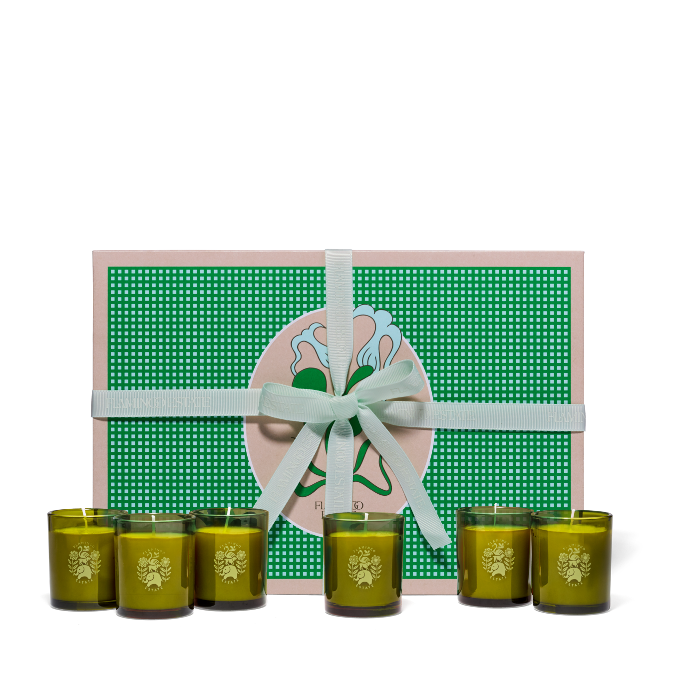 Six Flamingo Estate Garden Essentials Candles And Packaging Displayed In Front Of A Green Gift Set Box