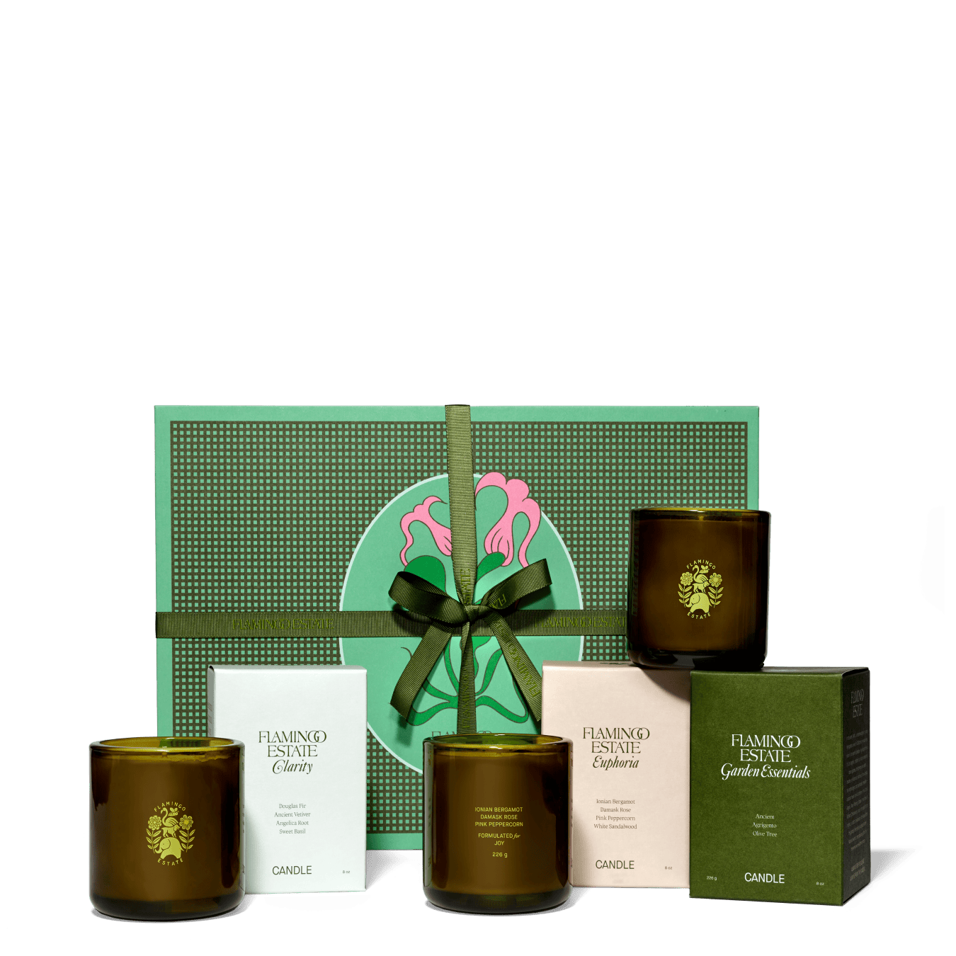 Flamingo Estate "Clarity", "Euphoria" And "Garden Essentials" Candles With Packaging Displayed In Front Of Green Gift Box