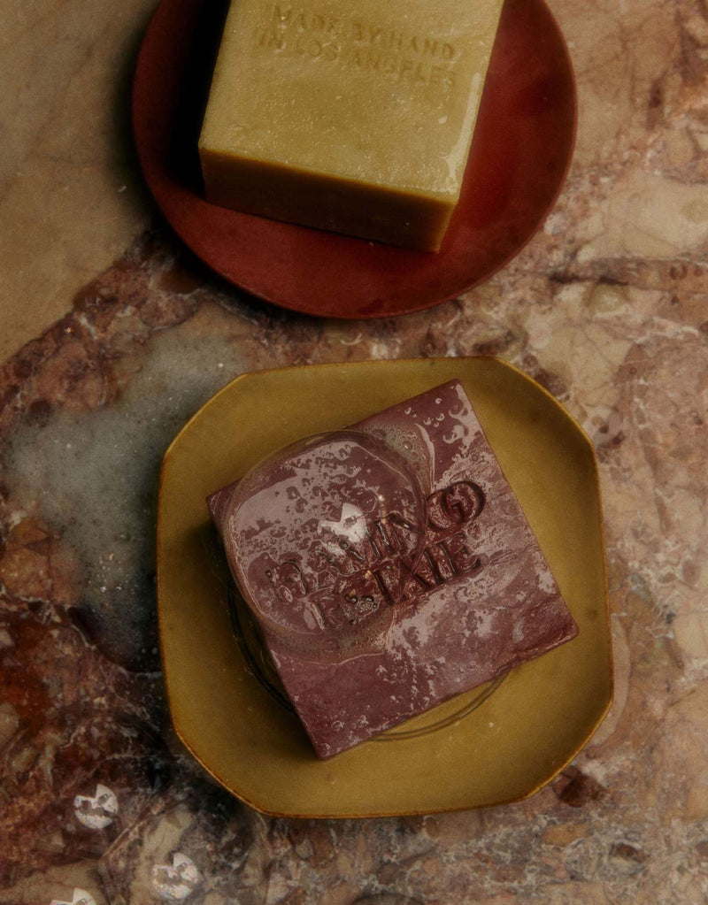 Flamingo Estate Soap Bricks Presented On Ceramic Dishes On A Marble Surface