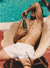 Man On A Seashell-Shaped Wicker Chair With A Flamingo Estate 