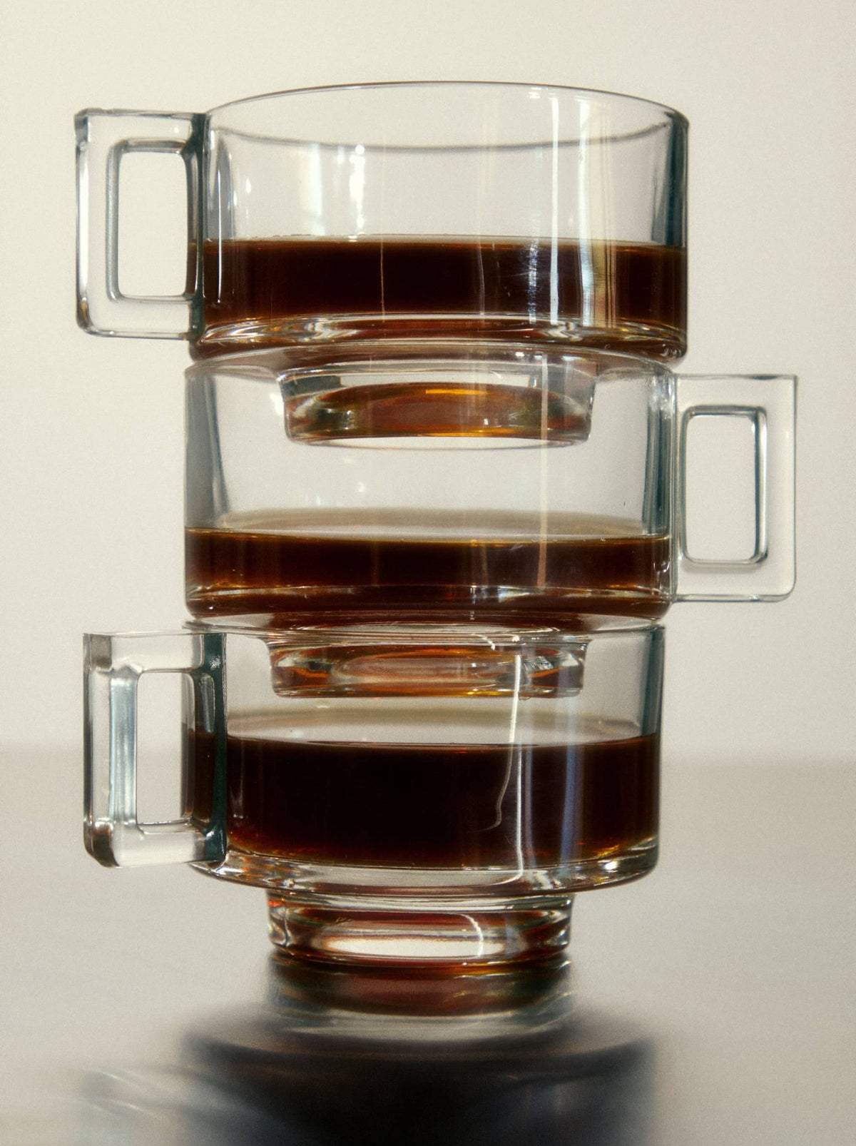 Three Stacked Glass Coffee Cups With Black Coffee